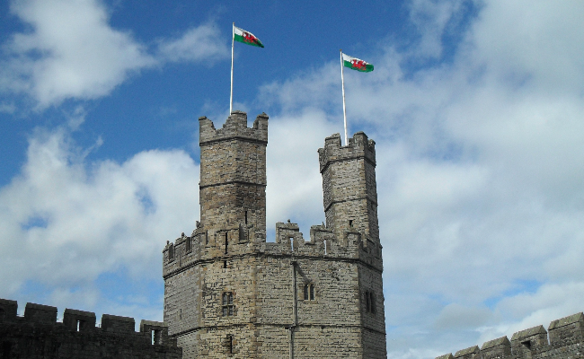 Welsh flag flying on the battlements of Caernarfon Castle
